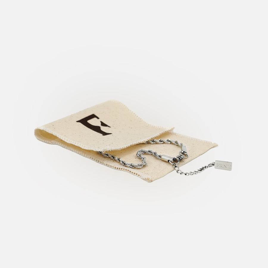 Premium silver snake chain bracelet by FRNE displayed with cotton storage pouch on white background