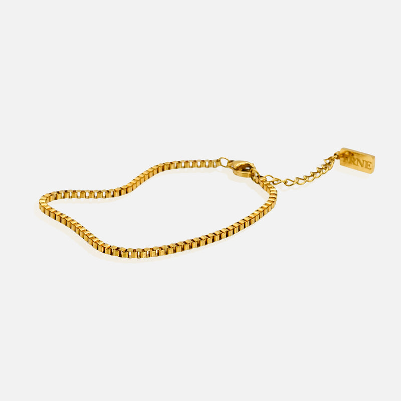 Gold box chain bracelet with extension chain on white background