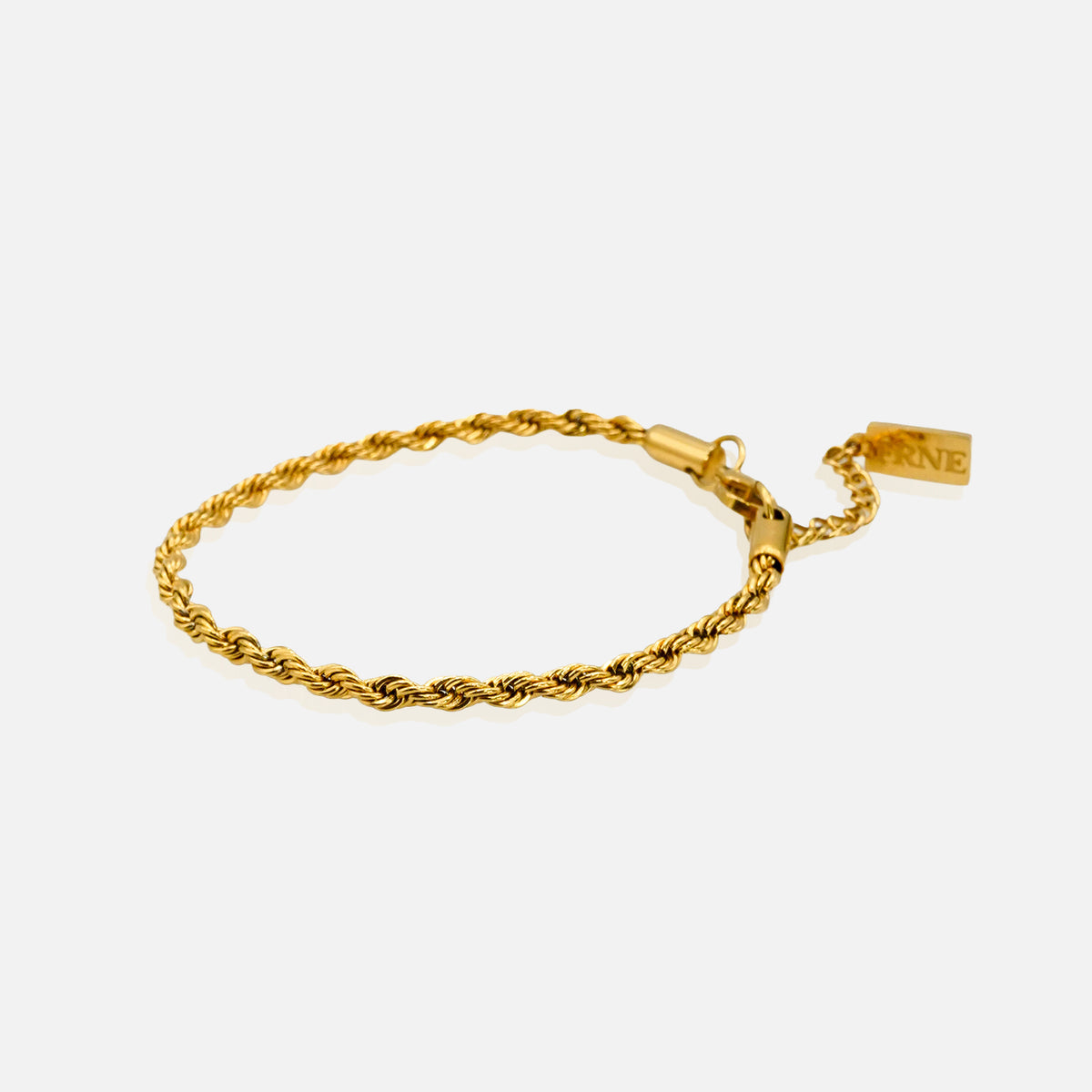 Gold rope bracelet with extension chain and clasp detail on white background