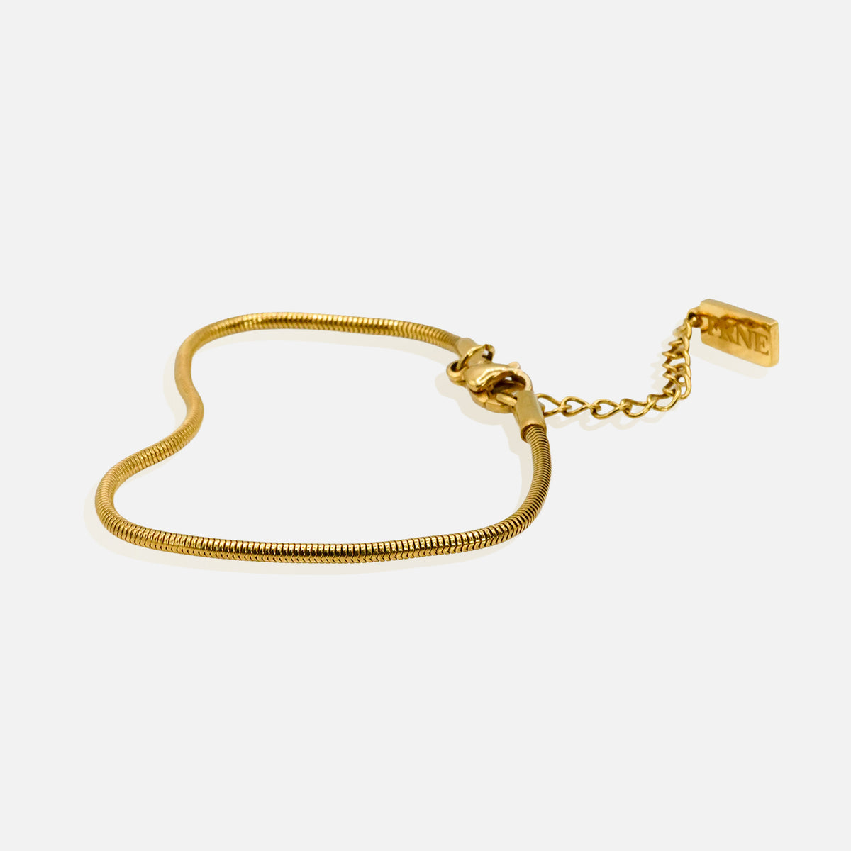 Premium gold snake chain bracelet by FRNE with minimalist design and extension chain on white background