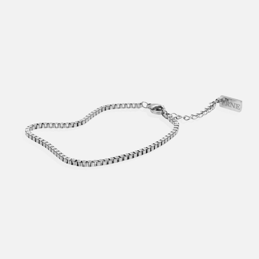 Silver refined box chain bracelet with extension chain on white background