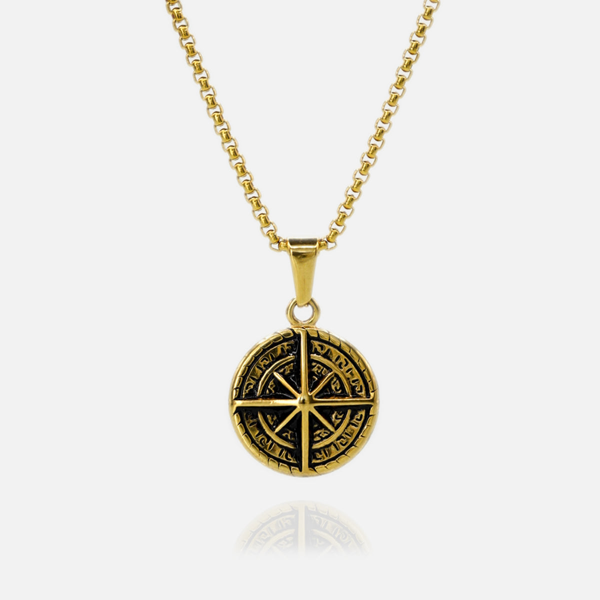 Gold necklace with a black pendant on a white background