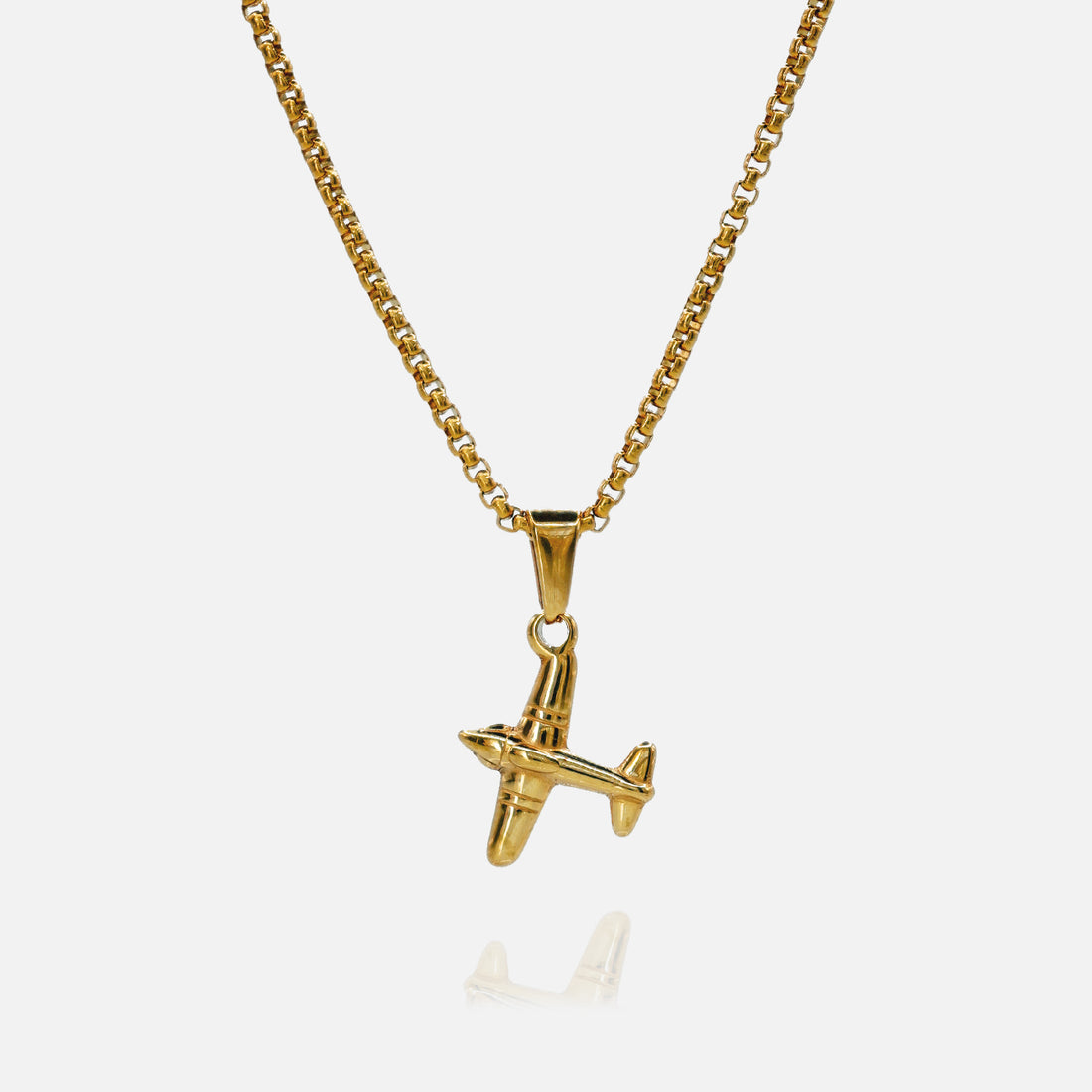 Gold airplane pendant necklace on a white background