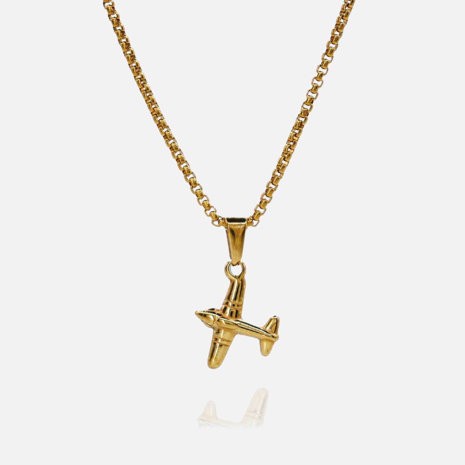 Gold airplane pendant necklace on a white background