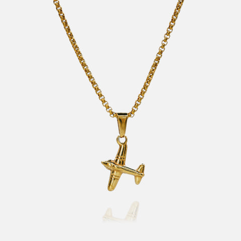 Gold airplane pendant necklace on a white background