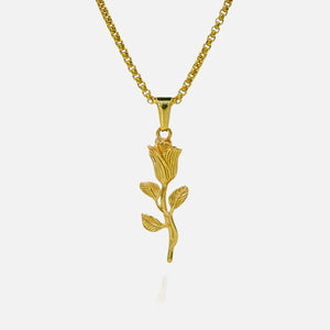 Gold rose-shaped pendant on a chain against a white background