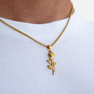Gold rose necklace on a white shirt