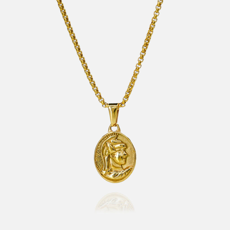 Gold necklace with a circular pendant on a white background
