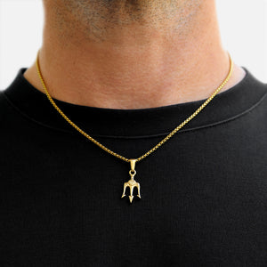 Gold necklace with a pendant on a black shirt against a white background