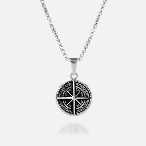 Silver necklace with a round pendant on a white background