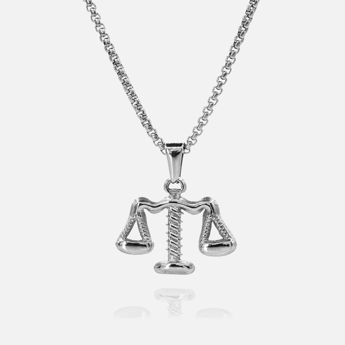 Silver Libra zodiac pendant on a chain against a white background