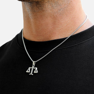 Silver necklace with a pendant worn by a person on a white background