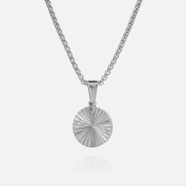 Silver necklace with a round pendant on a white background
