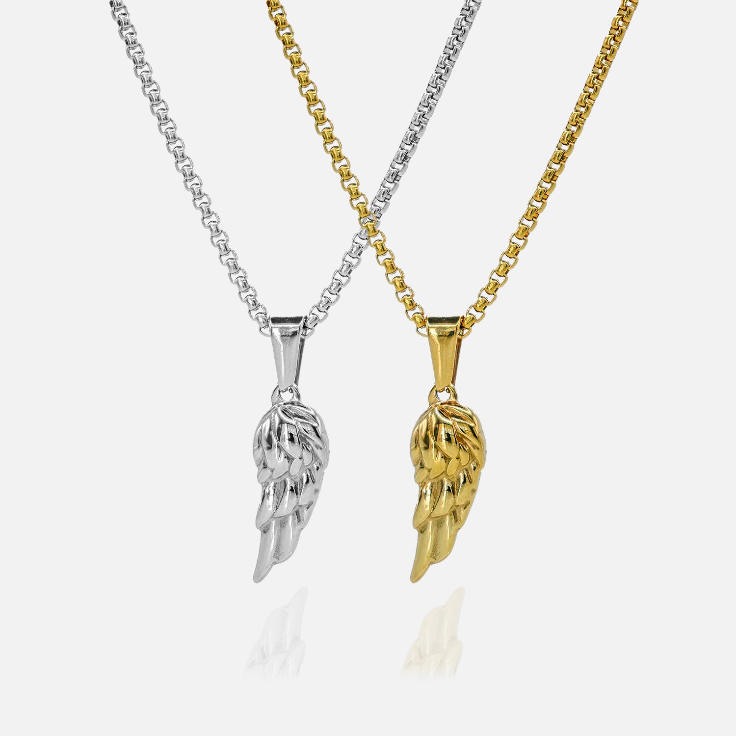 Two angel wing pendants, one silver and one gold, on white backgrounds.