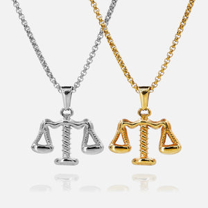 Two necklaces with Libra scale pendants, one silver and one gold, on a white background.