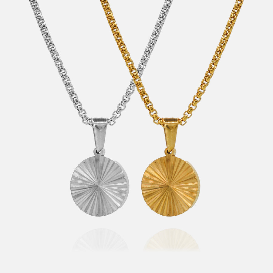 Two necklaces with circular pendants, one silver and one gold, on a white background.