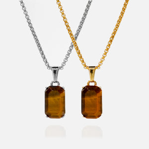 Two amber pendant necklaces on gold and silver chains against a white background