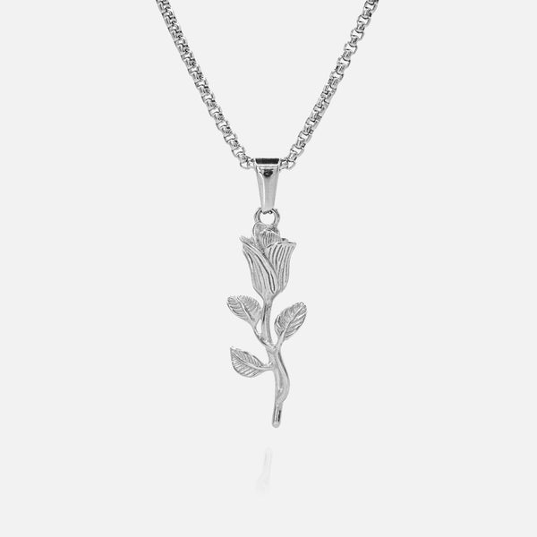 Silver rose-shaped pendant on a chain against a white background