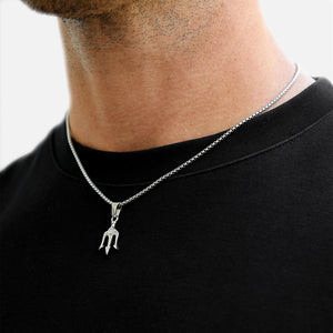 Silver necklace with a pendant worn by a person on a black shirt