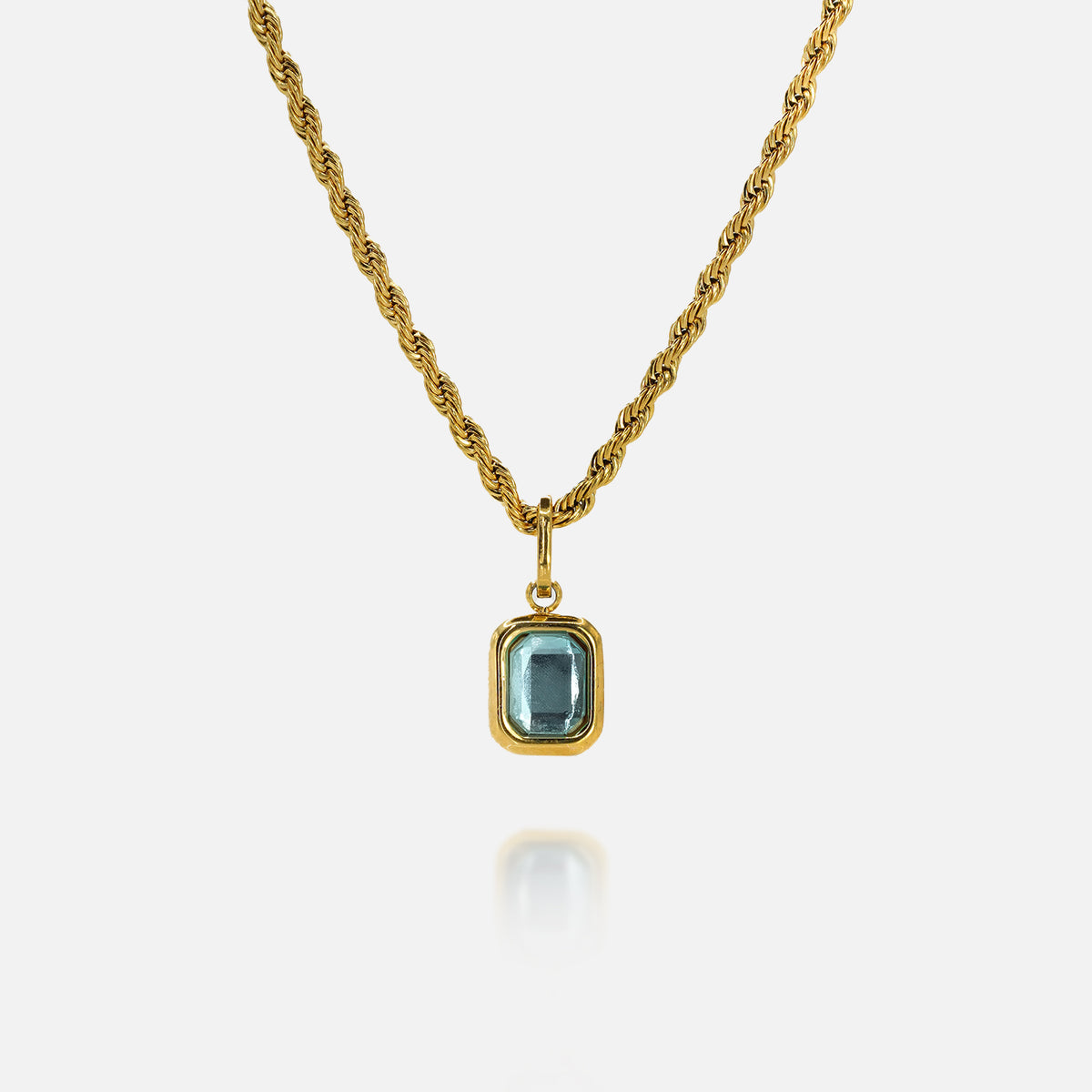 FRNE glacier blue gemstone gold pendant necklace featuring a rectangular light blue stone set in a gold frame on a twisted gold chain, isolated on a clean white background