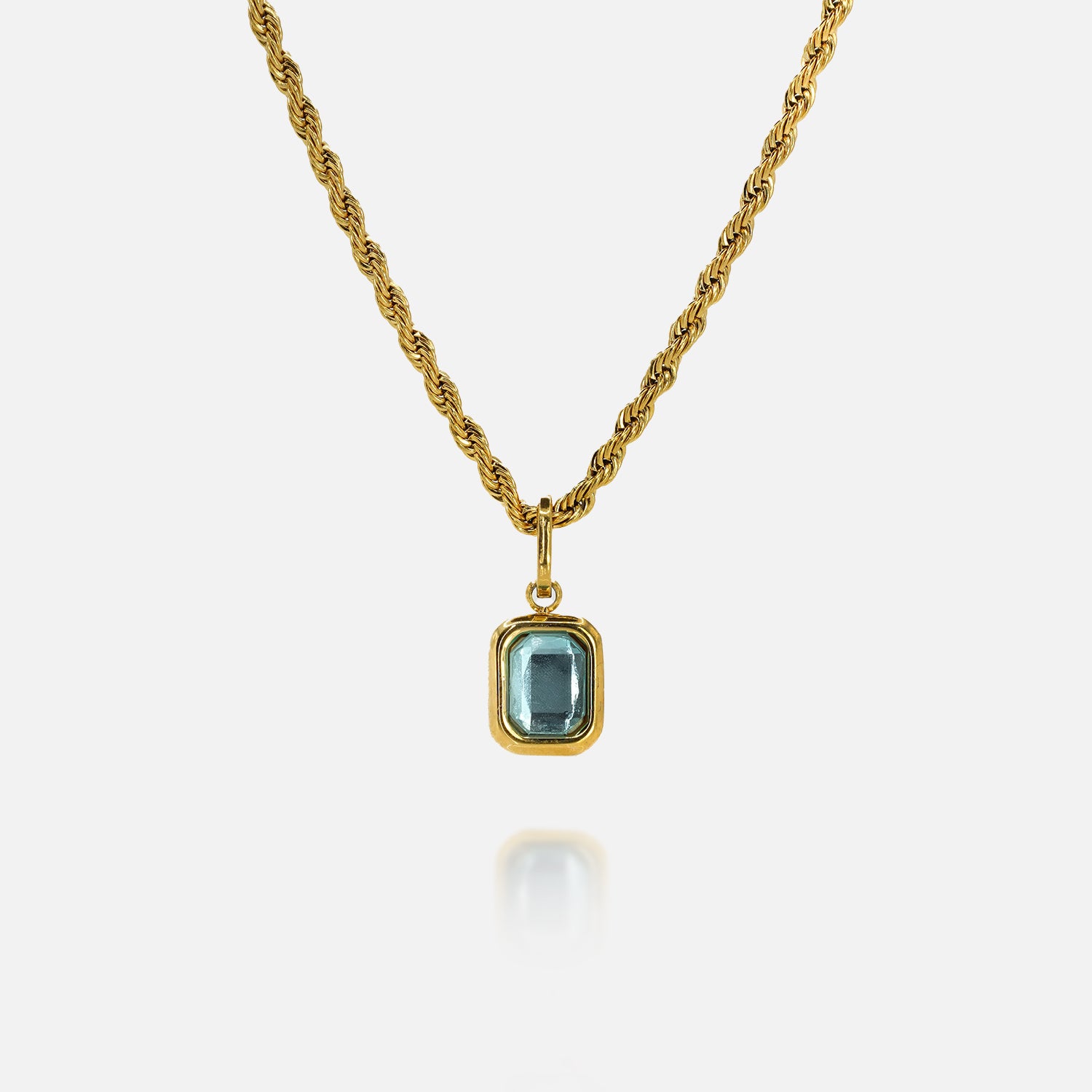 FRNE glacier blue gemstone gold pendant necklace featuring a rectangular light blue stone set in a gold frame on a twisted gold chain, isolated on a clean white background