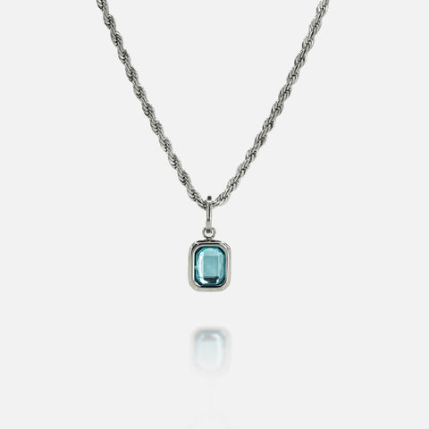 FRNE glacier blue gemstone silver pendant necklace with rectangular light blue stone on a silver chain isolated on a white background