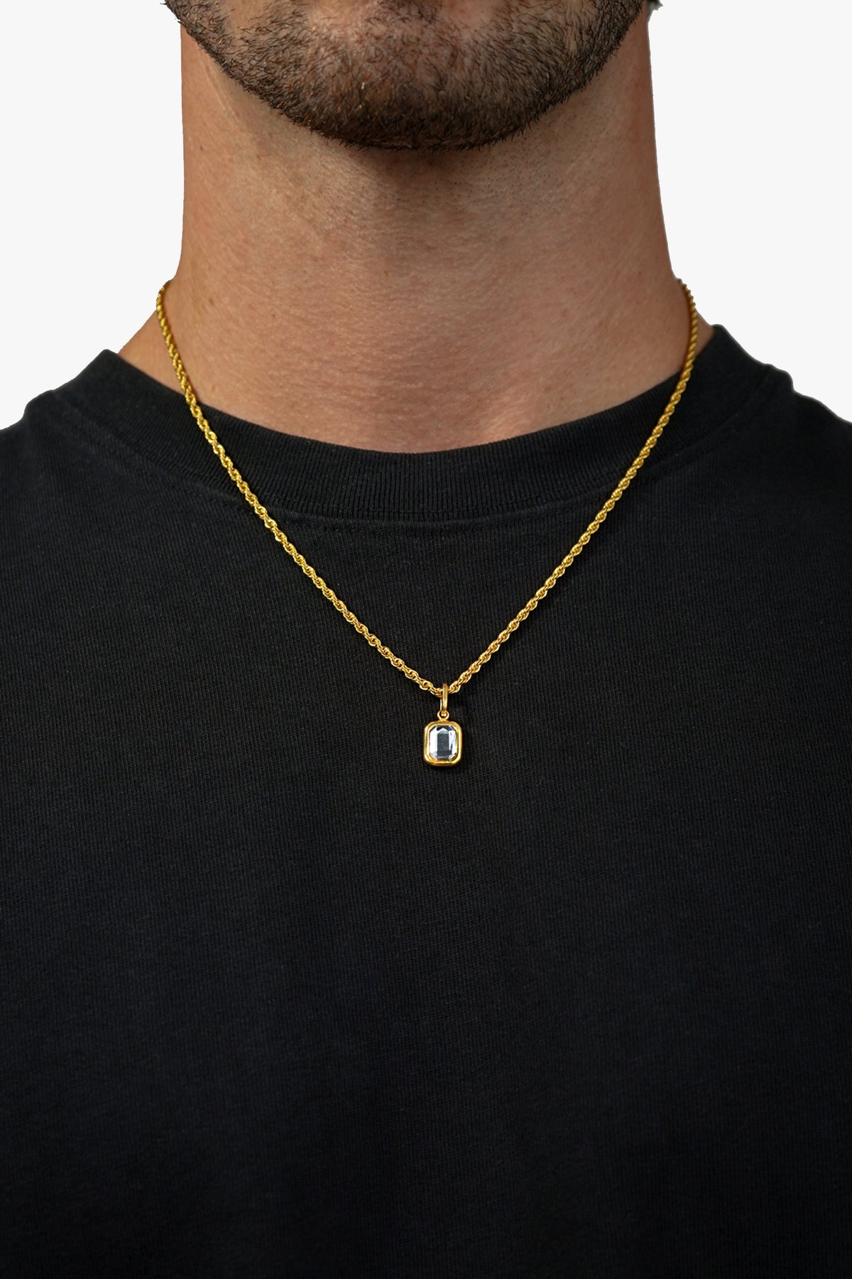 FRNE gold tanzanite pendant necklace with blue gemstone worn on neck with black shirt close up