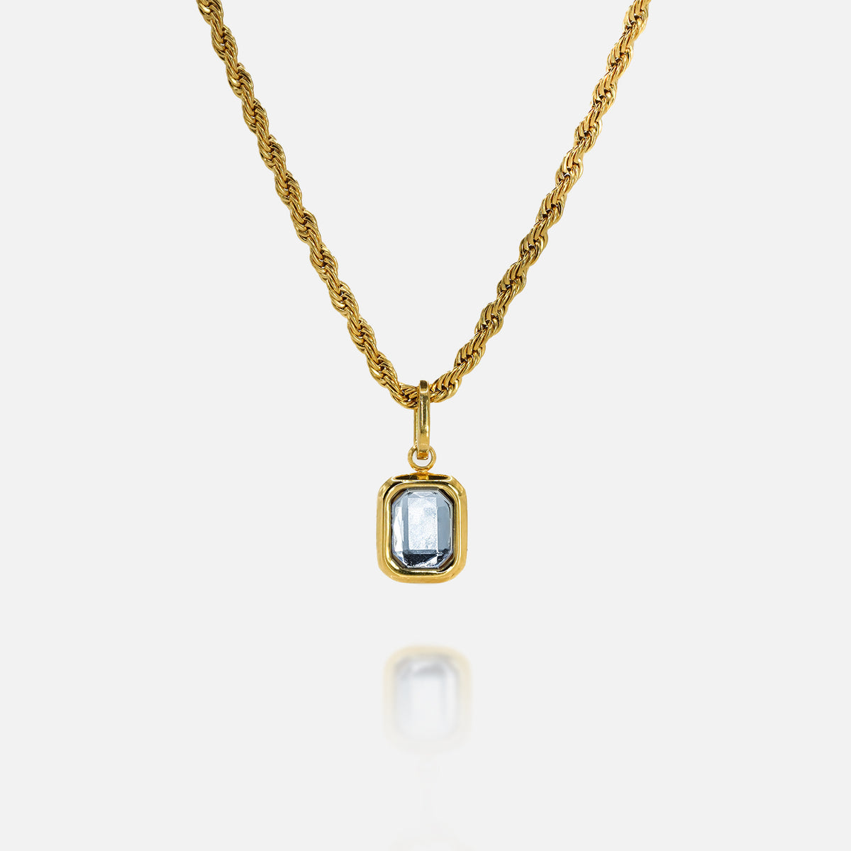 FRNE gold tanzanite pendant necklace with rectangular blue gemstone on white background