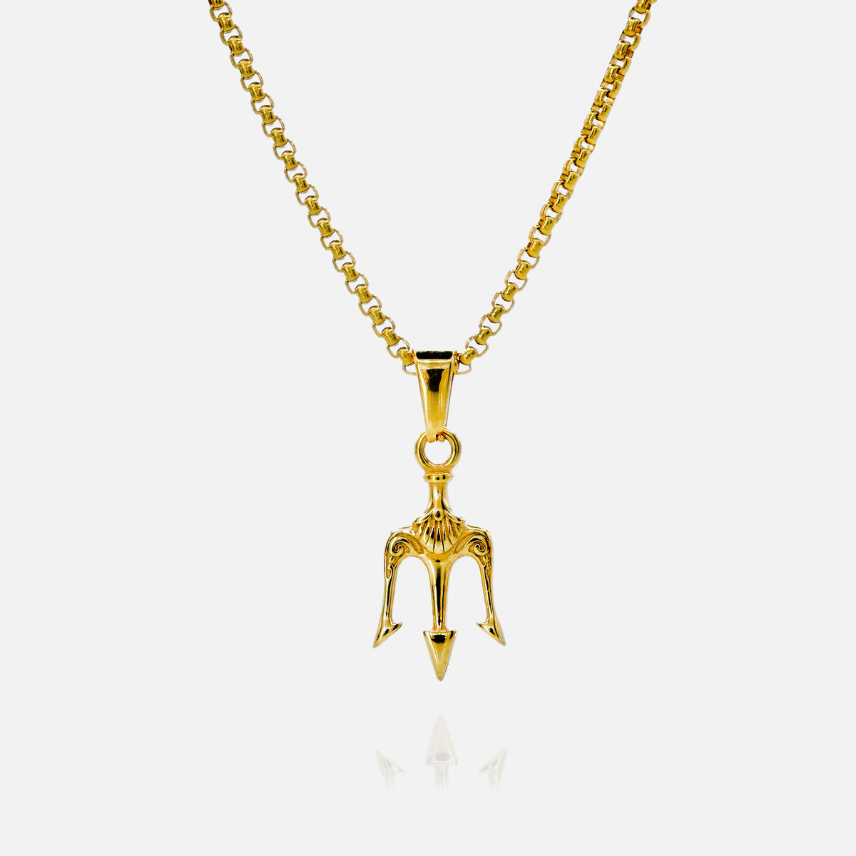 Gold trident pendant necklace on a gold chain displayed against a white background with a subtle reflection below