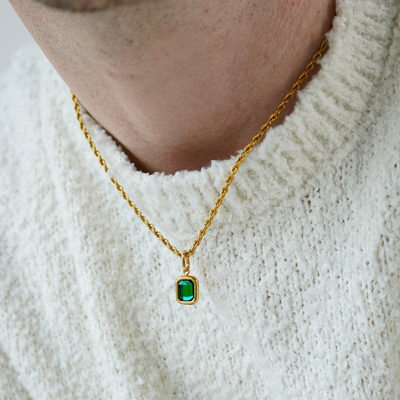 FRNE lucky gem green gemstone gold necklace worn by a person, featuring a rectangular emerald-green pendant on a gold chain, styled with a textured white sweater for a clean, minimal look