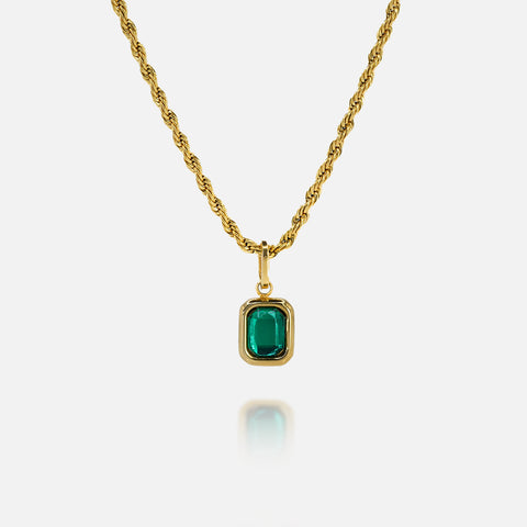 FRNE lucky gem green gemstone gold necklace featuring a rectangular emerald-green pendant set in a gold frame on a gold chain, displayed on a clean white background with a subtle reflection below