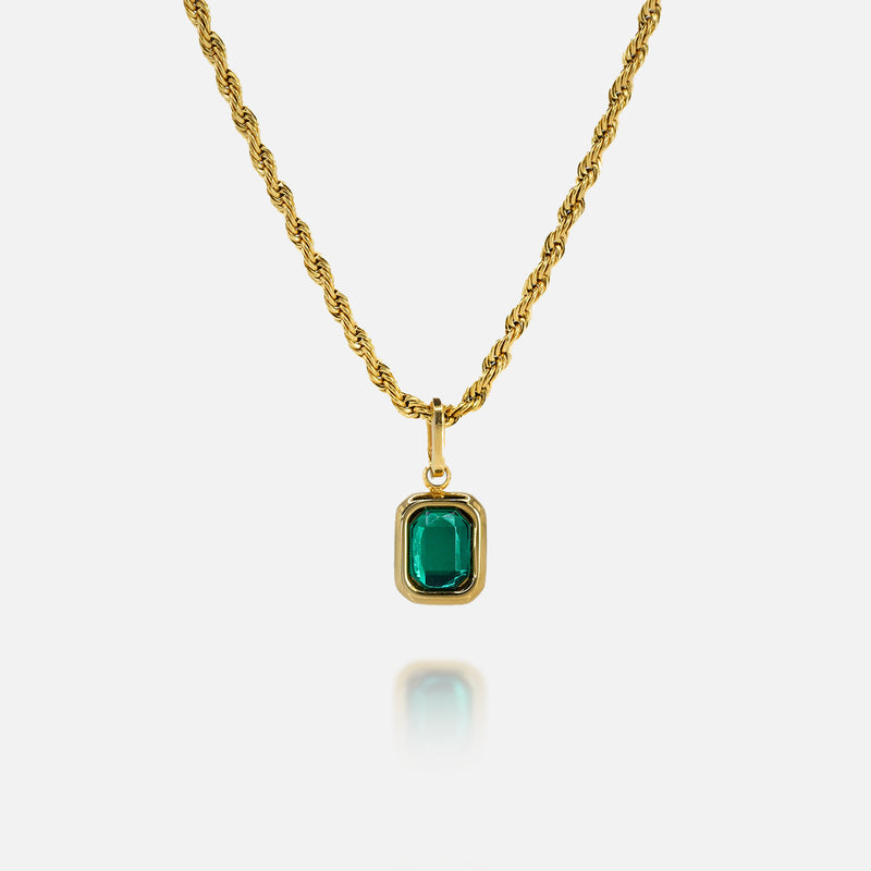 FRNE lucky gem green gemstone gold necklace featuring a rectangular emerald-green pendant set in a gold frame on a gold chain, displayed on a clean white background with a subtle reflection below