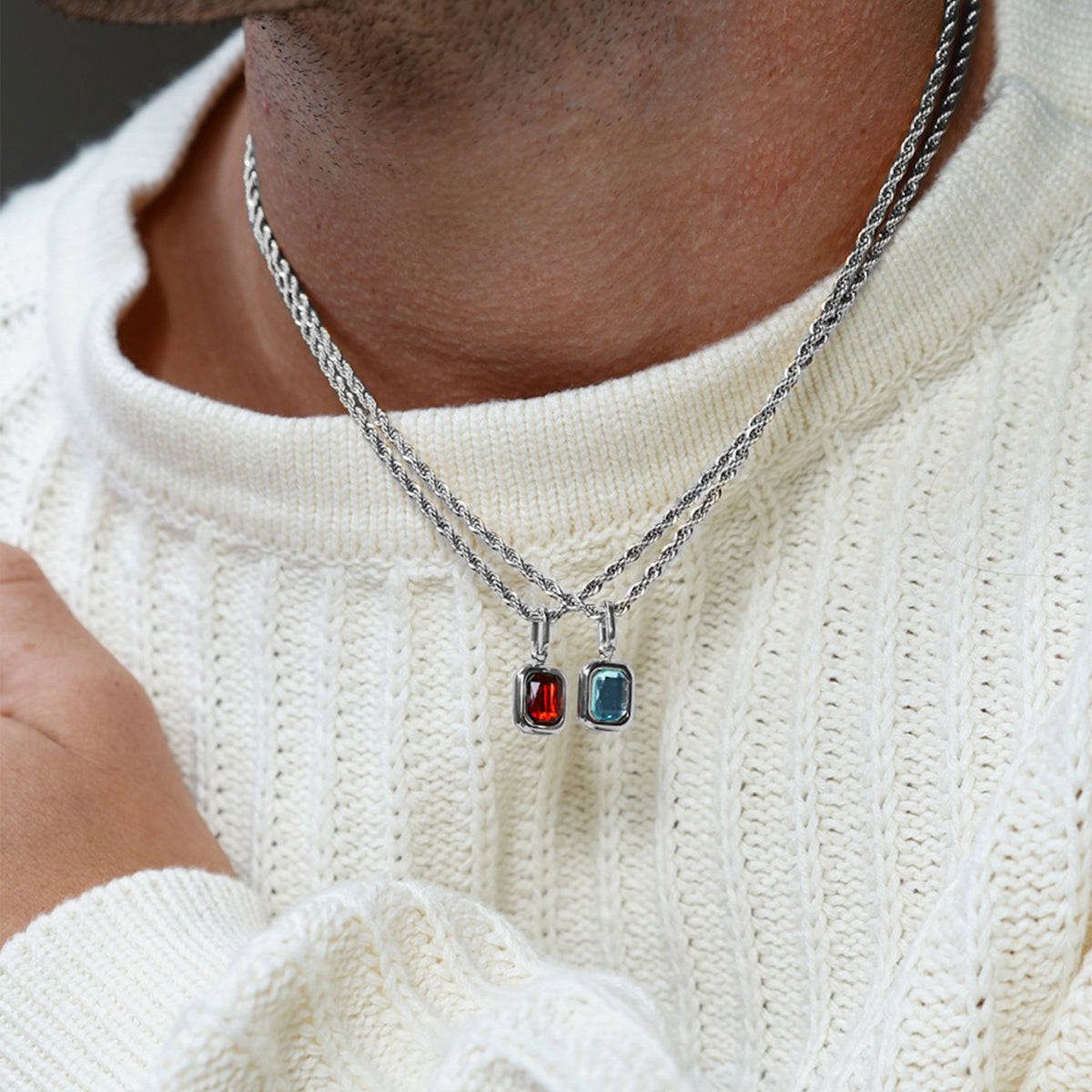 FRNE men’s sterling silver layered necklaces with red and blue gemstone pendant charms worn with knit sweater