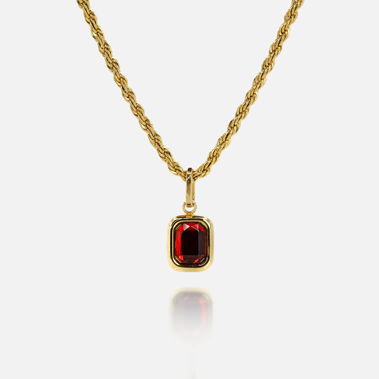FRNE ruby centre red gemstone gold necklace on a white background, featuring a rectangular deep red stone pendant set in a polished gold frame on a twisted rope-style gold chain