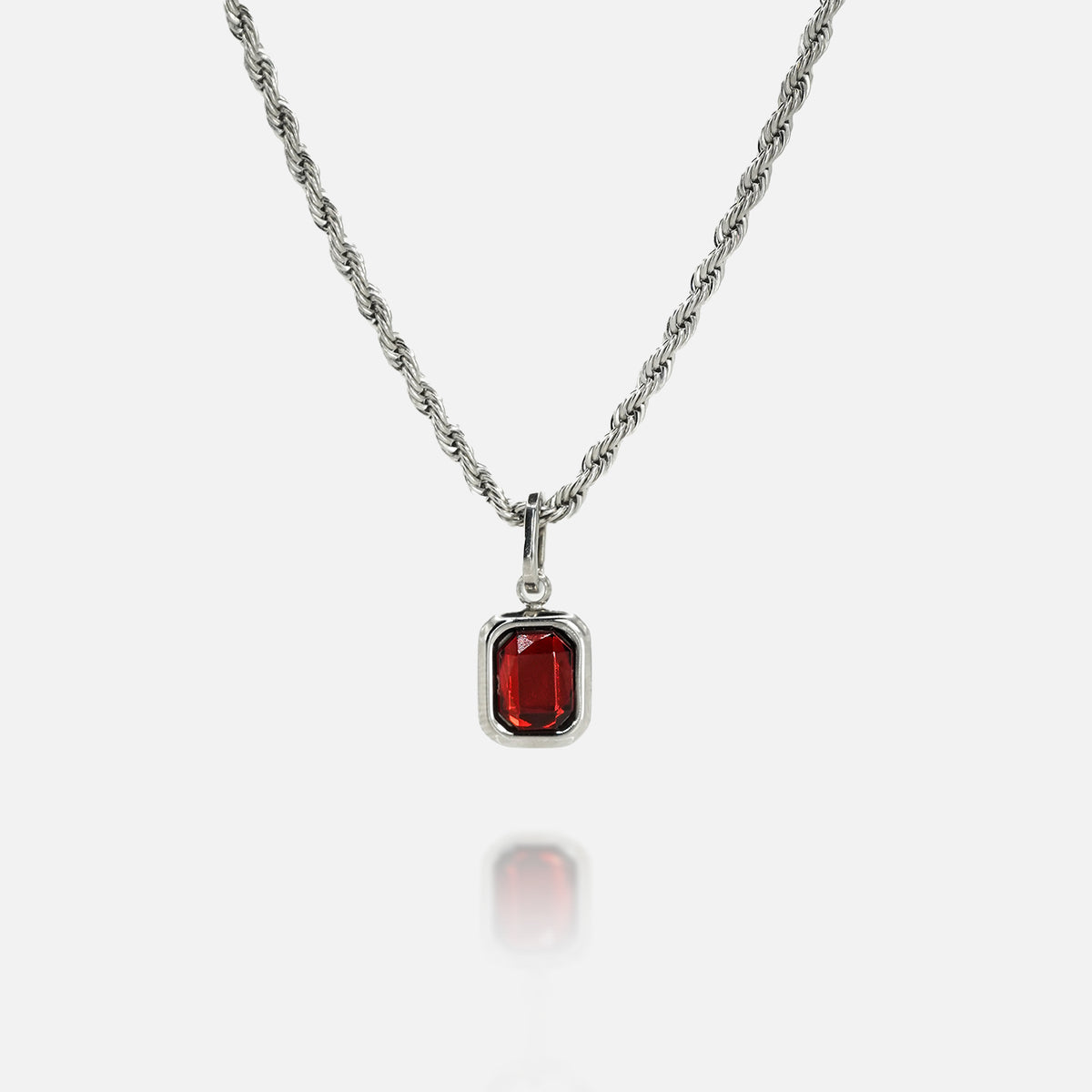 FRNE ruby flame red gemstone silver necklace on a white background, featuring a rectangular deep red stone pendant set in a polished silver frame on a twisted rope-style silver chain