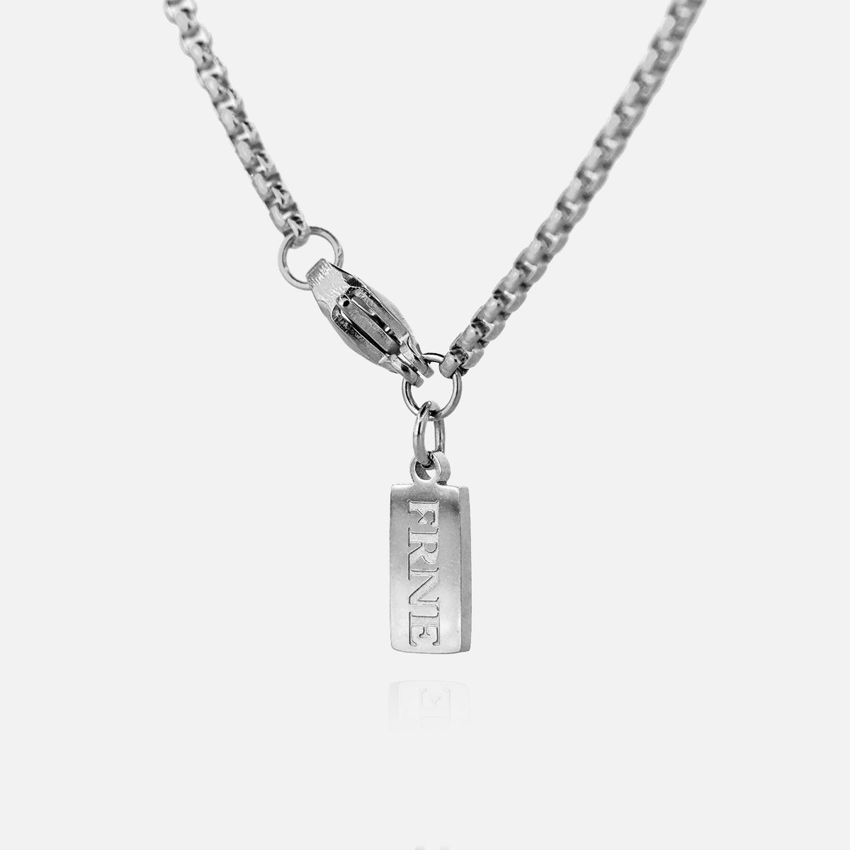 Silver tag pendant necklace with FRNE engraving on a silver chain against a white background